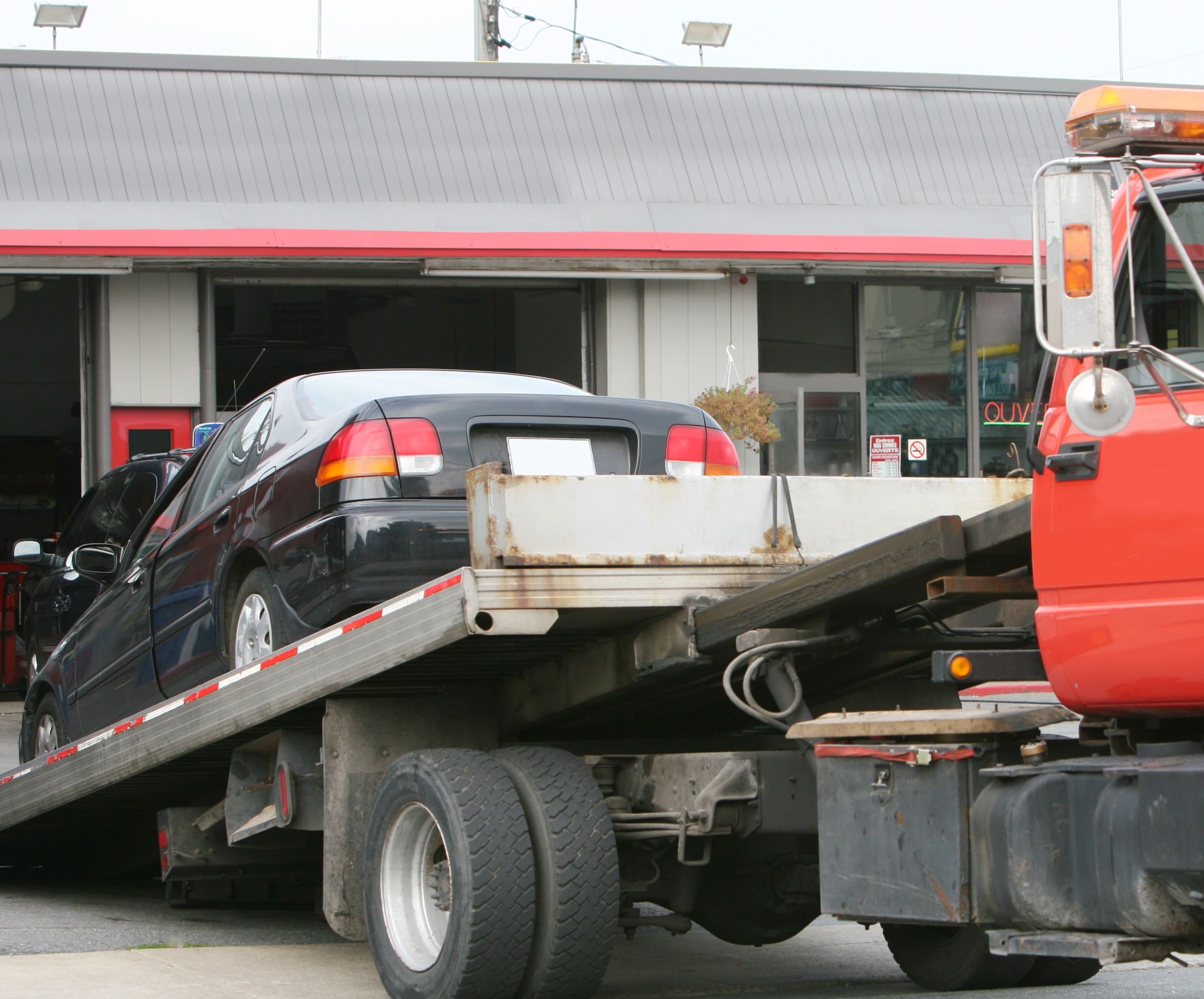Car being loaded onto a tow truck.
