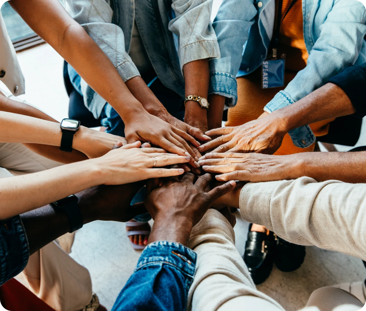 Hands together in a circle, showing unity.