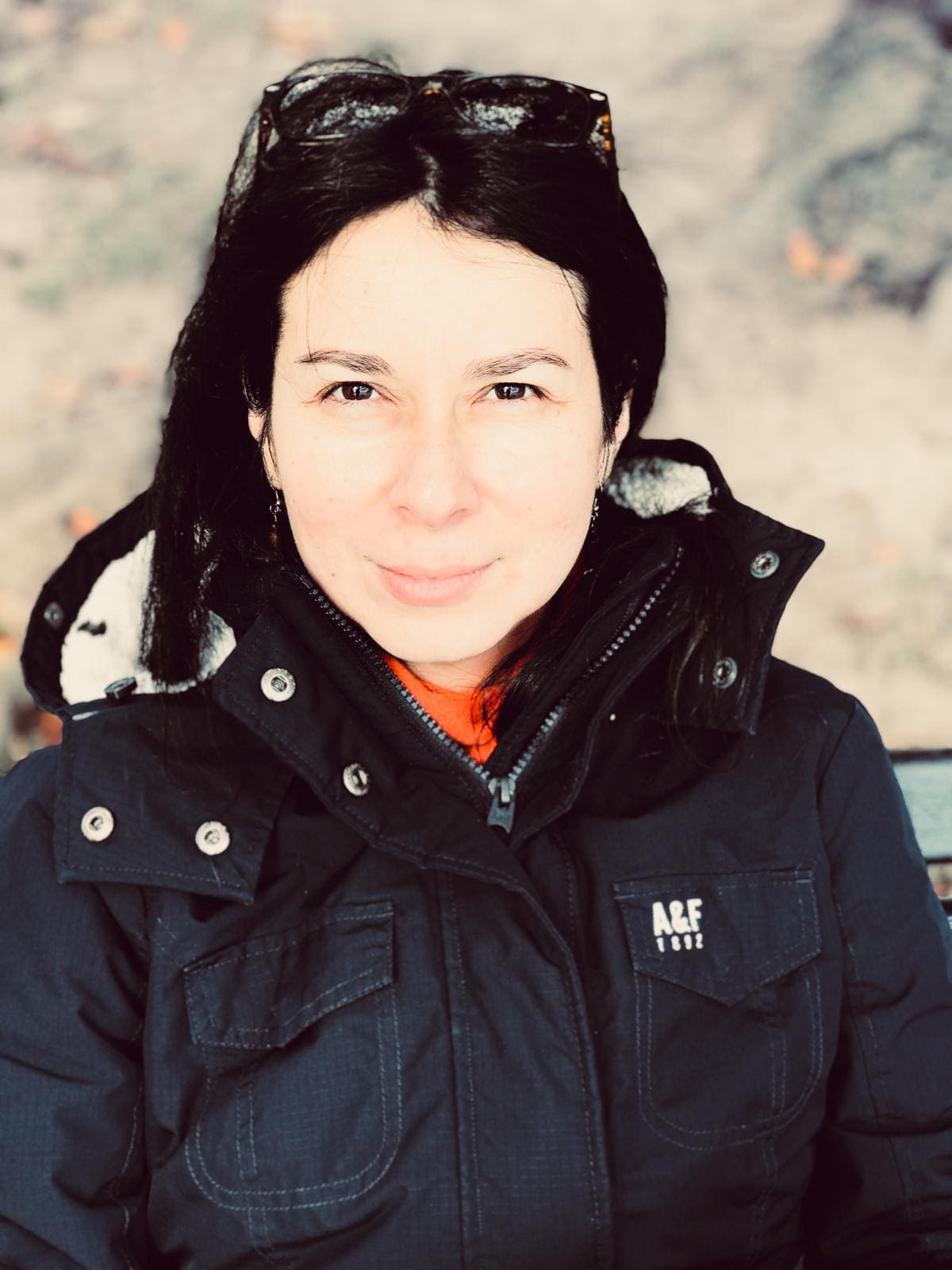 Woman in winter coat smiling at camera.