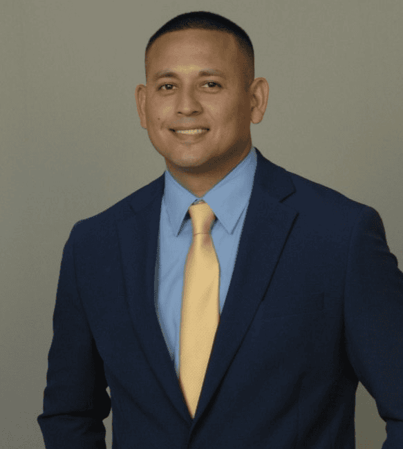 Professional man in a suit smiling confidently.