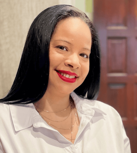 Smiling woman with long black hair.